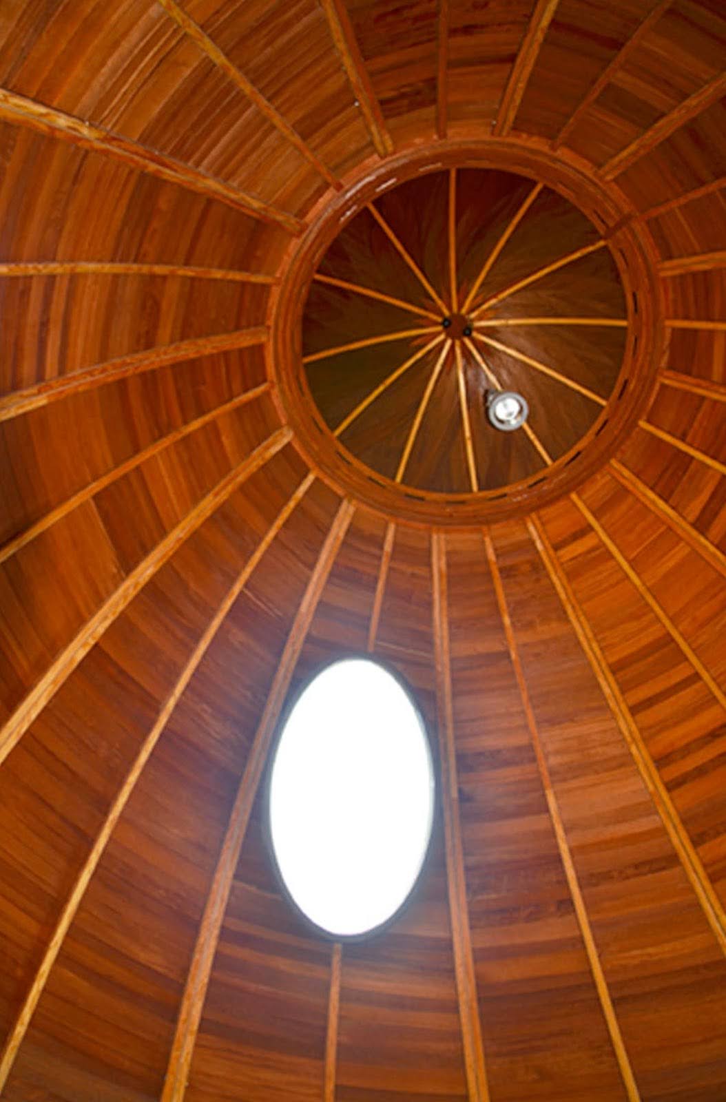 An oval wooden roof with an oval window cut out from it