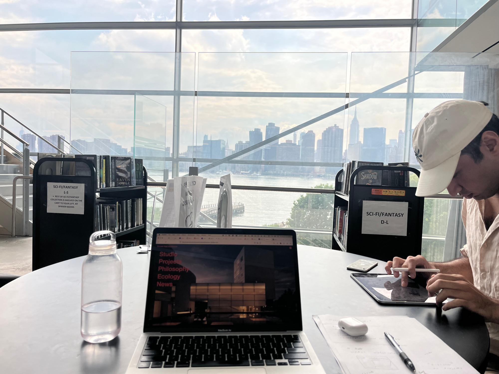 Omar Rizwan working on his iPad alongside Laurel Schwulst at Hunters Point Library in Queens